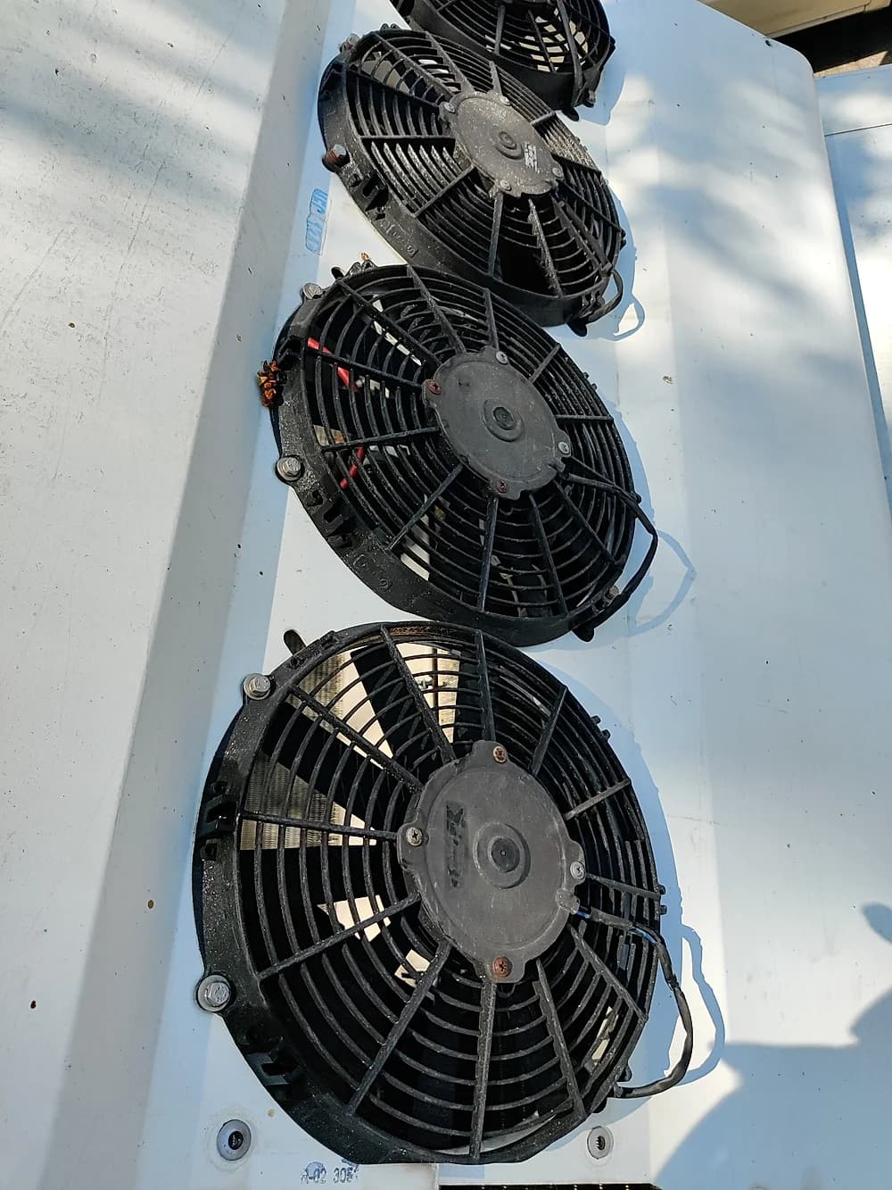 Close-up of commercial condenser fan motors during a maintenance inspection