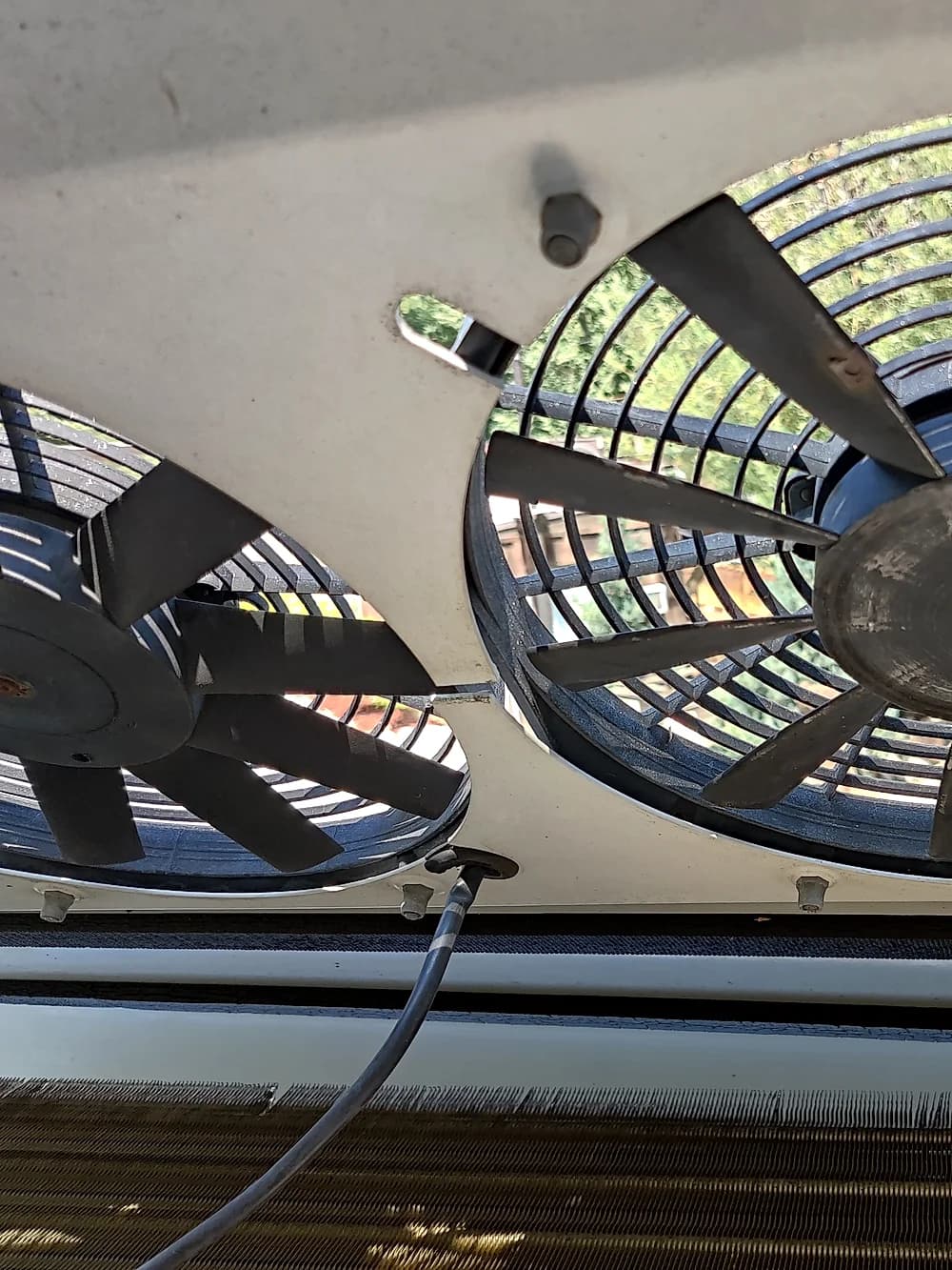 Close-up of condenser fan blades during a commercial HVAC repair